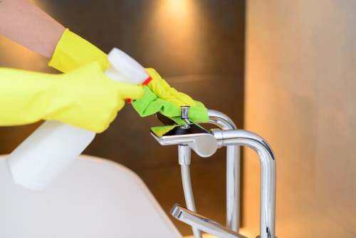 Technician applying cleaning solution with careful safety precautions