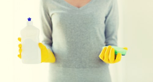 Upholstery cleaner treating a fabric sofa in a Pimlico flat